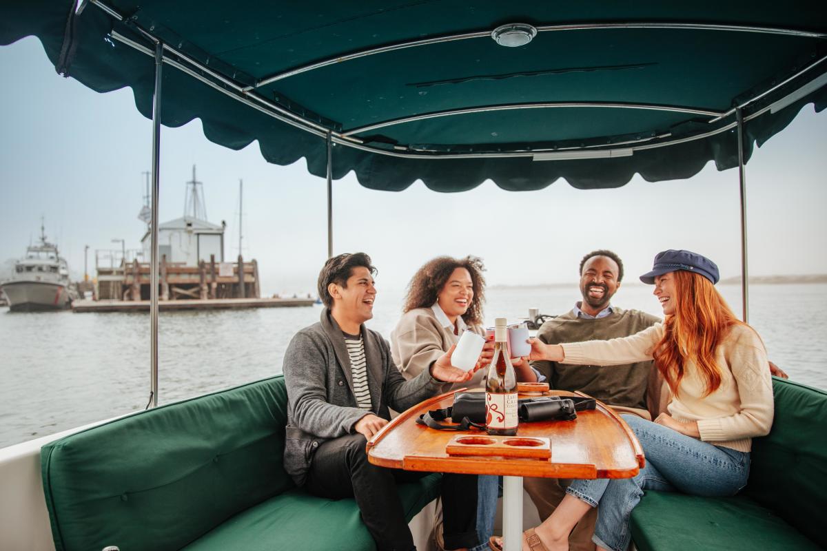 friends enjoying drinks on a harbor cruise around Morro Bay