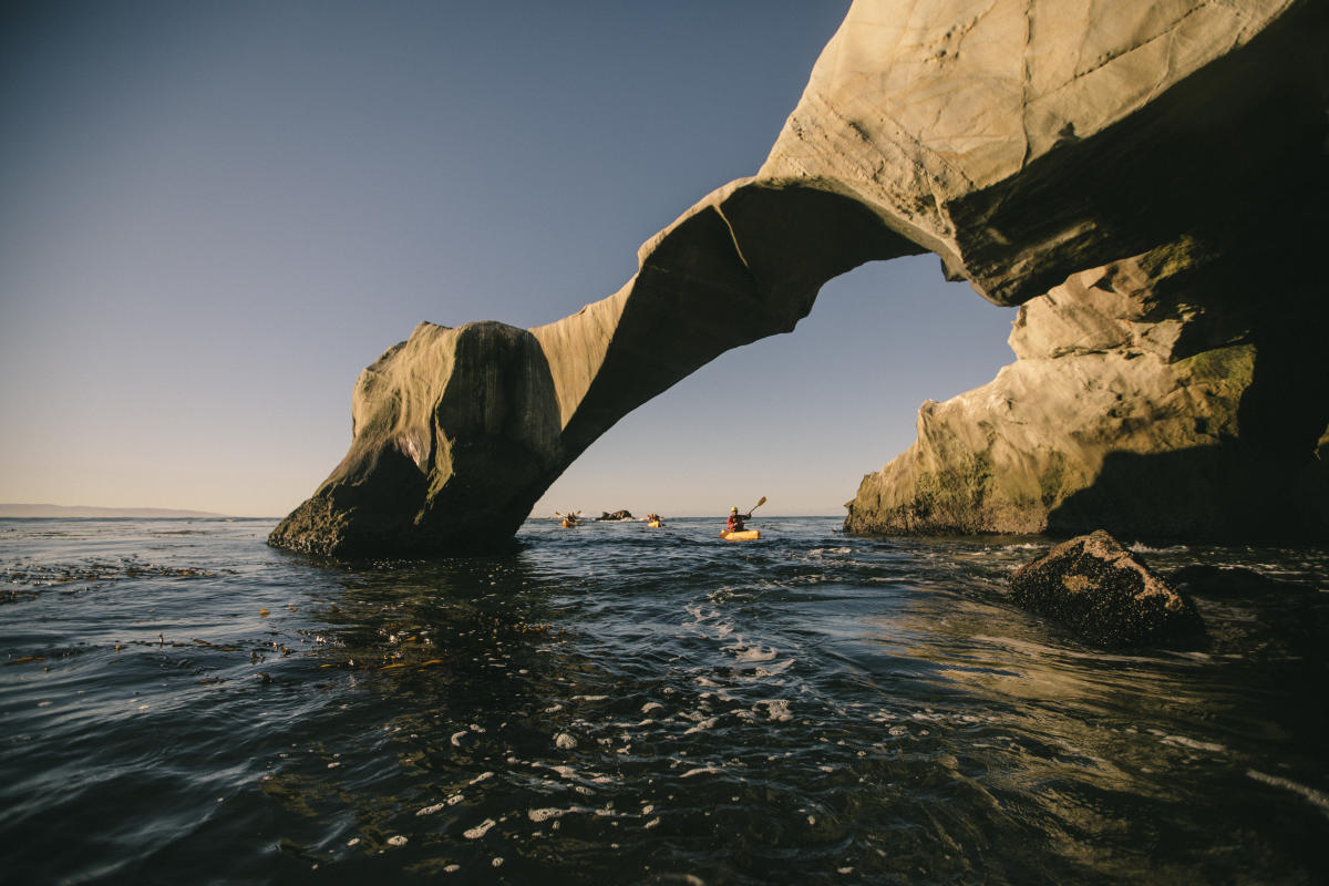 Kayakers paddling through Dinosaur Caves in San Luis Obispo