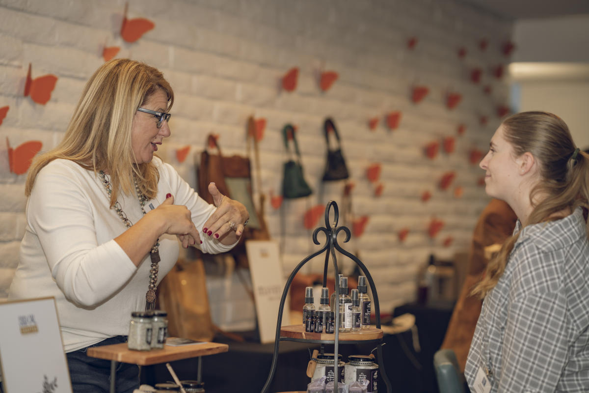 vendor and shopper conversation at pop-up marketplace