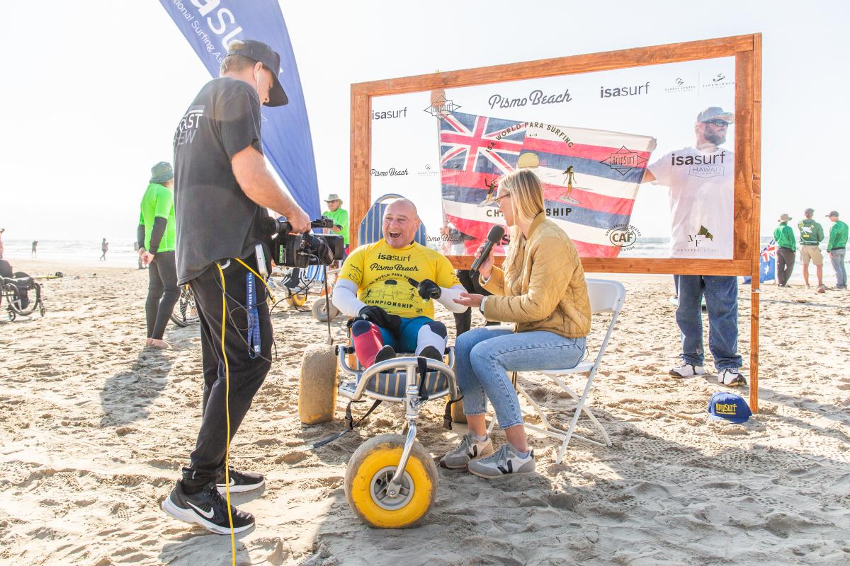 Surf contestant being interviewed at the ISA World Para Surfing Championships in Pismo Beach