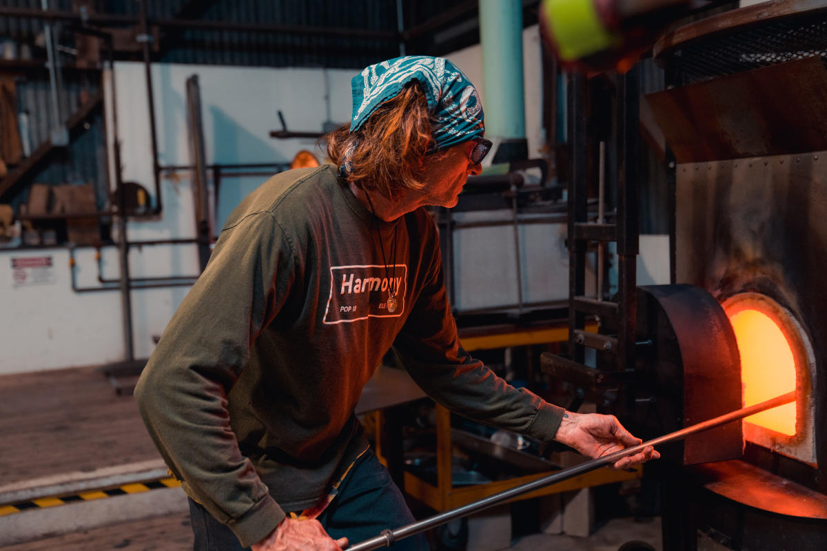 Man putting glass in the fire