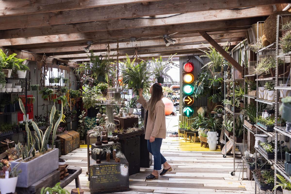 Woman shopping for plants at The Place on PCH