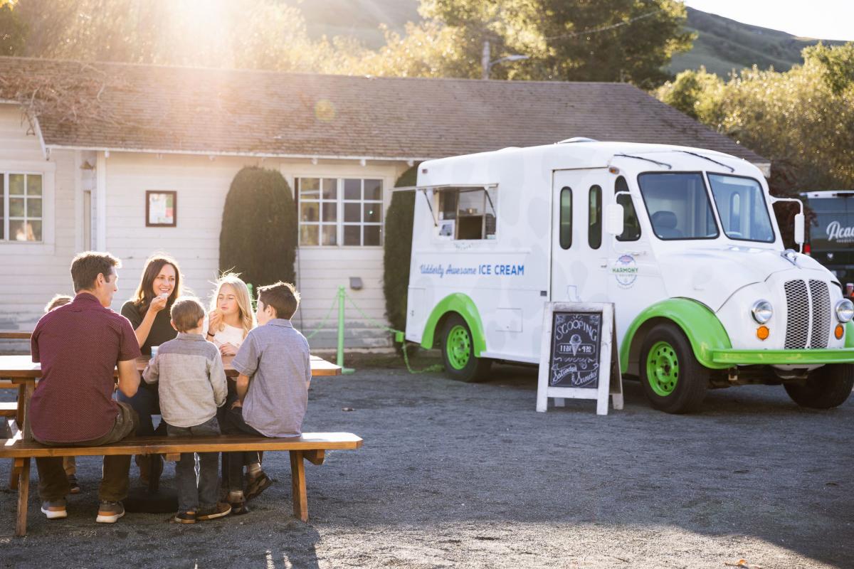 Family eating ice cream outside Harmony Valley Creamery scoop truck