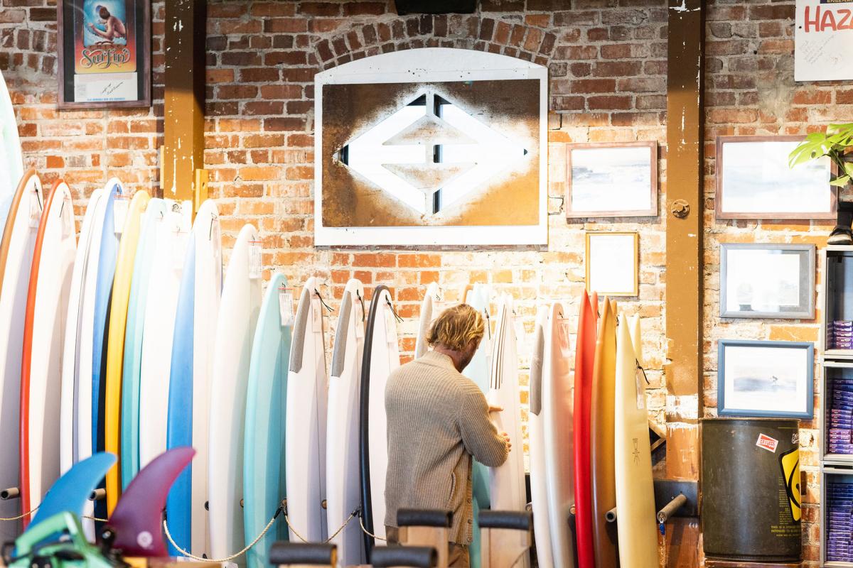 man shopping for surfboards at Esteem Surf Co in Pismo Beach