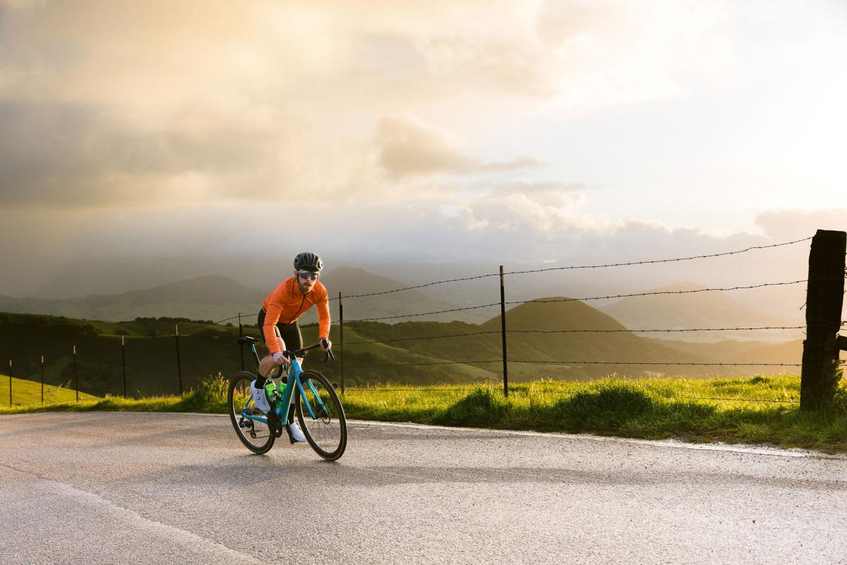 Man cycling on a backroad in SLO CAL