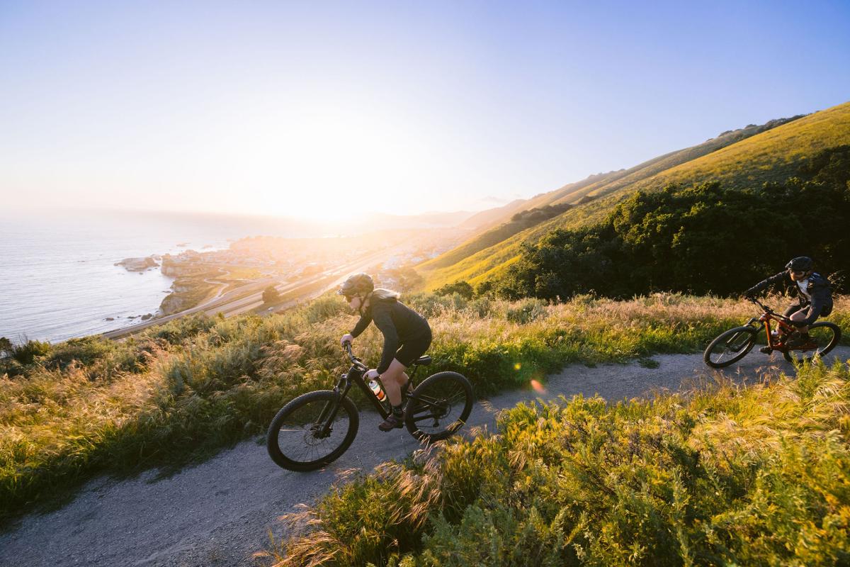 two cyclers biking on trail in Pismo Beach