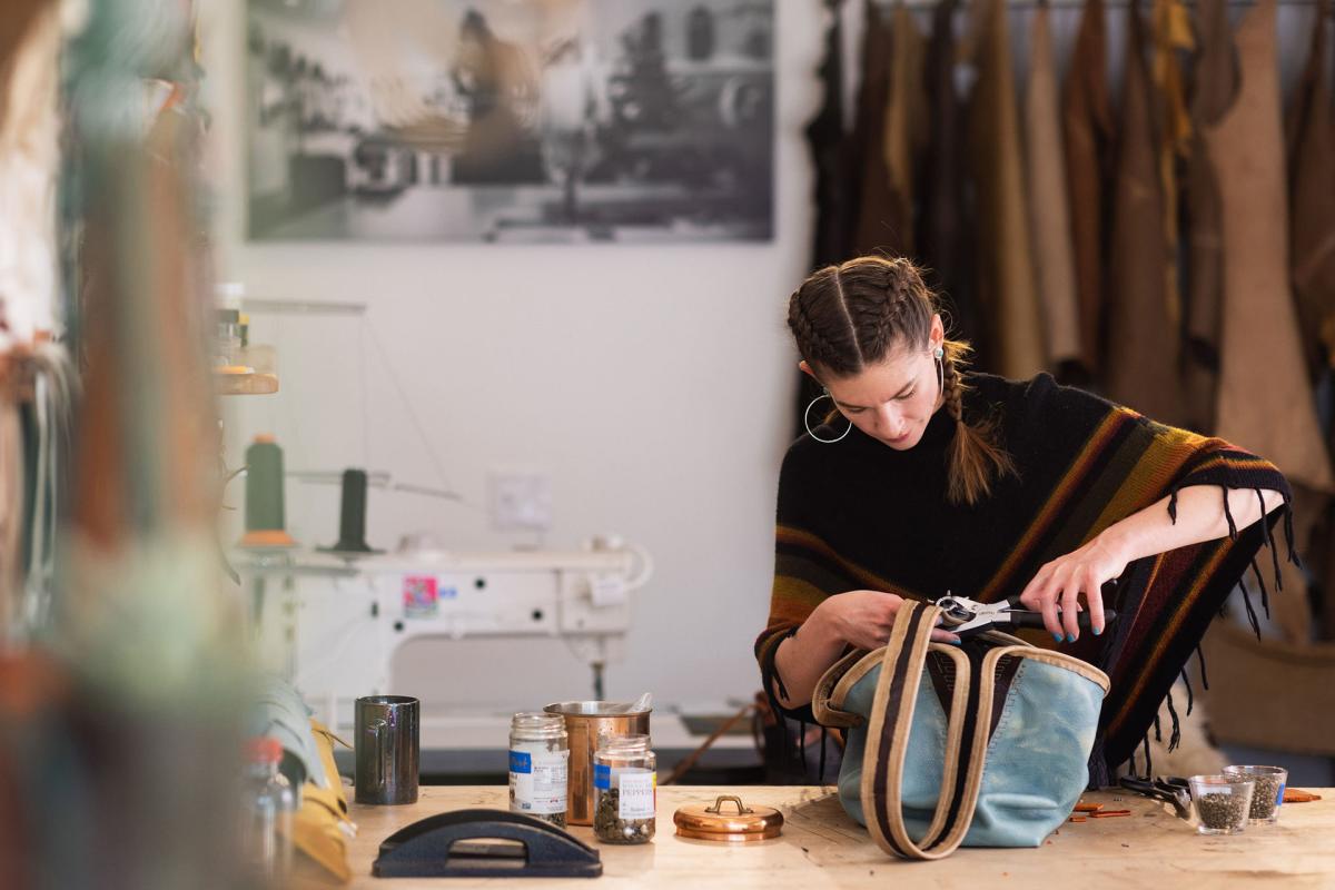 Emma Thieme of Maven Leather hand making a leather bag with sustainable materials