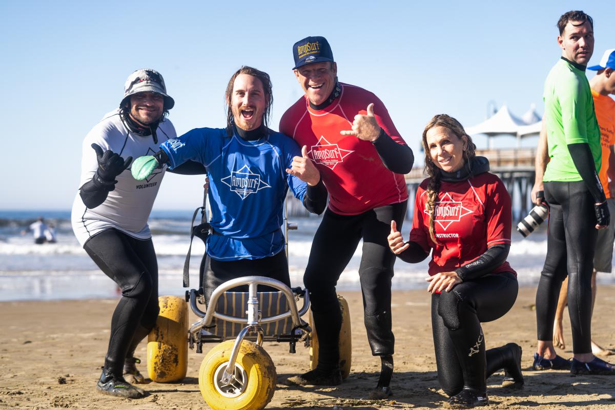 Dana Cummings of AmpSurf with surfer and instructor