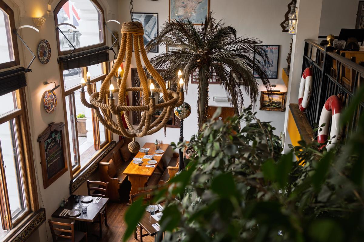 Inside of La Regata Restaurant with rustic tables and chairs