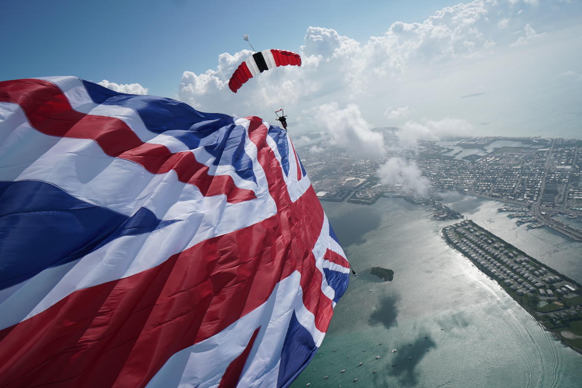 Large union jack flag flying through air in plane air display