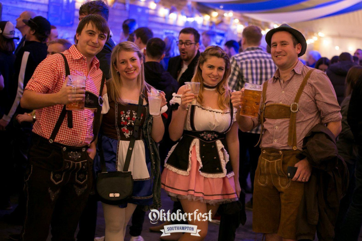 Group of people dressed up with beers for Oktoberfest