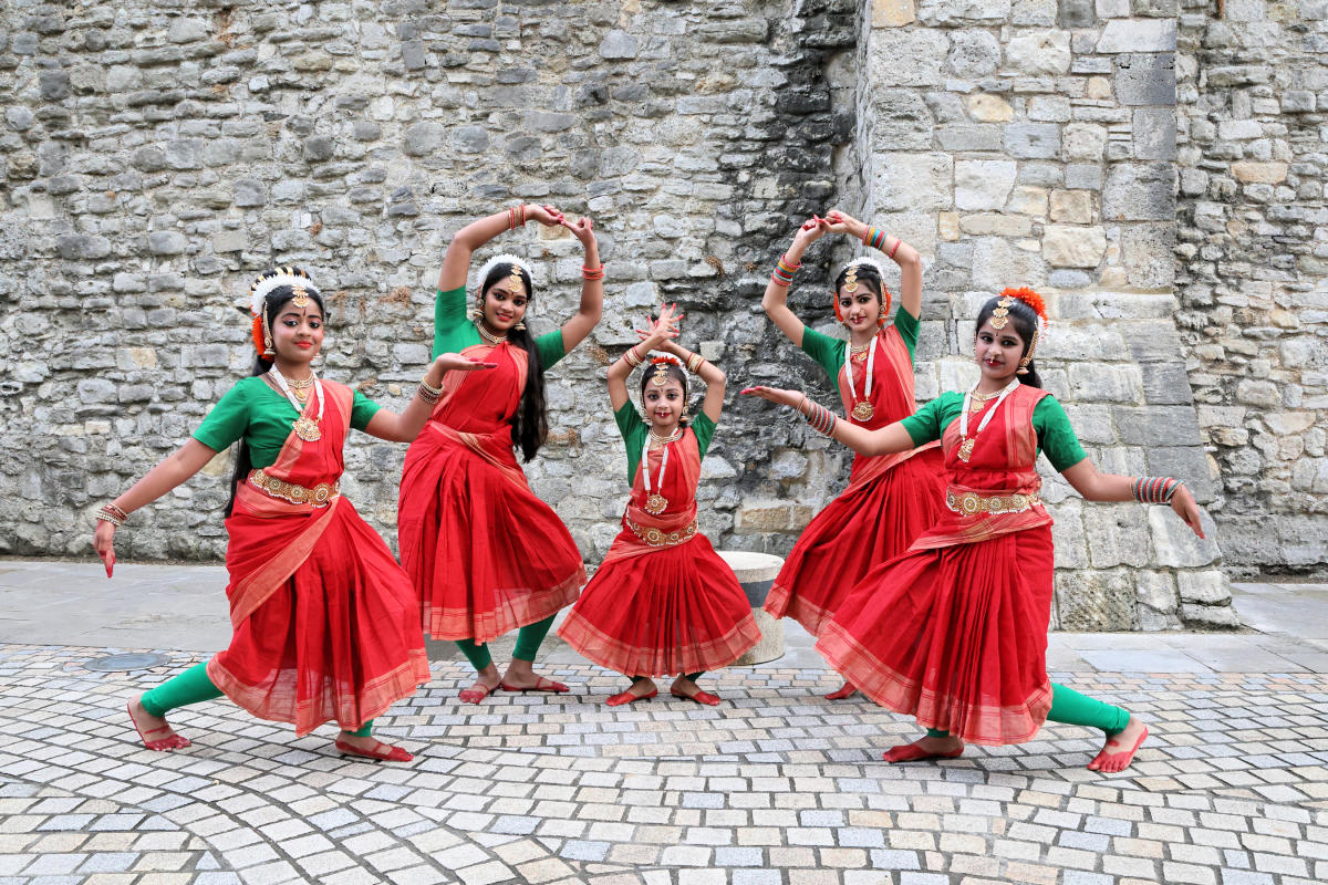 Young women dressed in traditional Indian dresswear performing a dance at Music In The City 2025