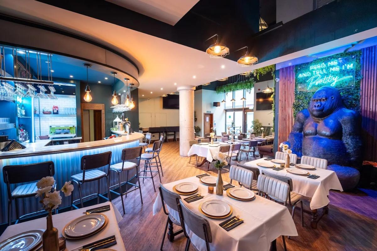 Interior dining area of Pierogarnia Southampton Polish restaurant with cream table cloth table settings and warm lighting