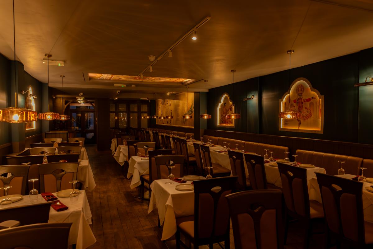 Interior seating area of Tattva Indian restaurant with classy tables and mood lighting