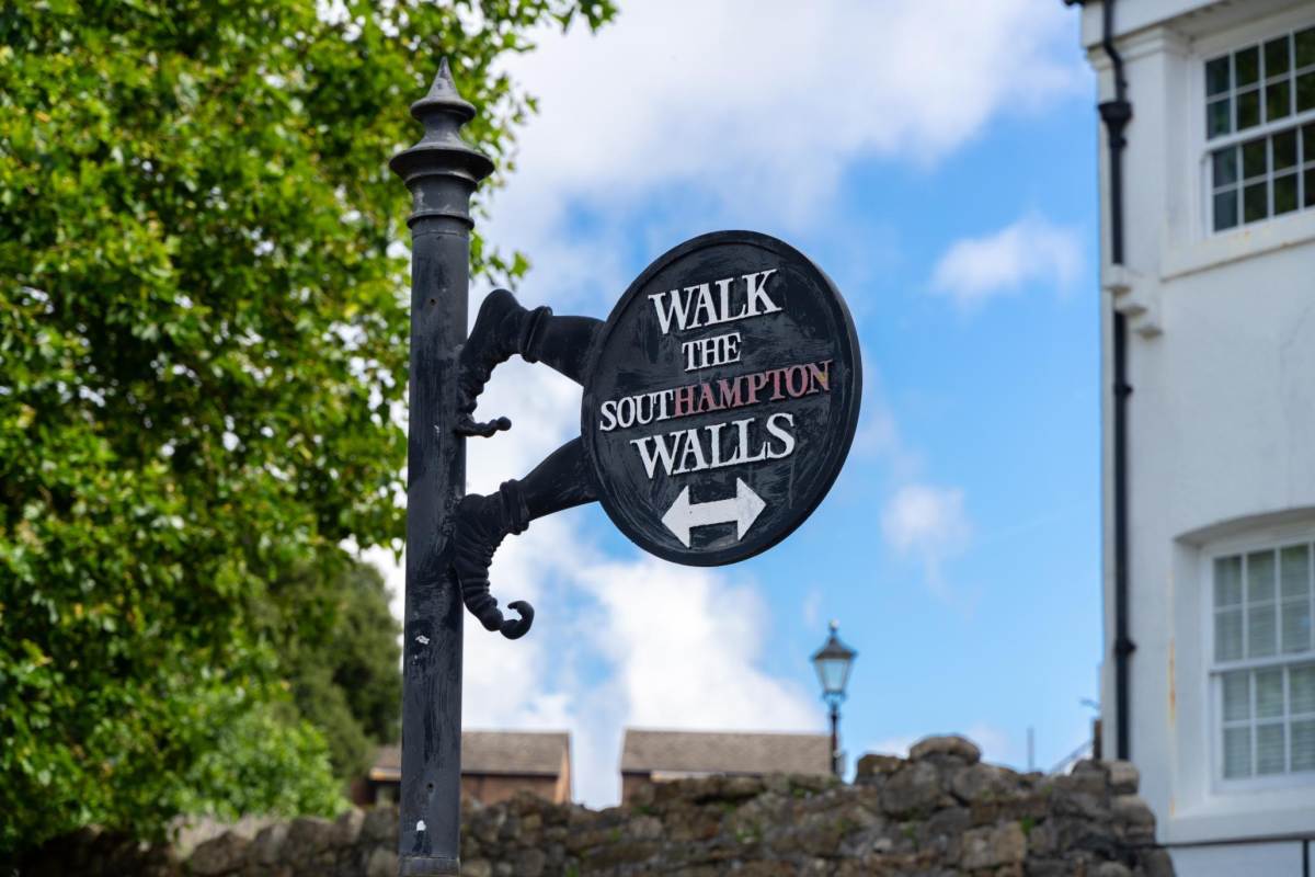 Walk the southampton walls metal sign on black post