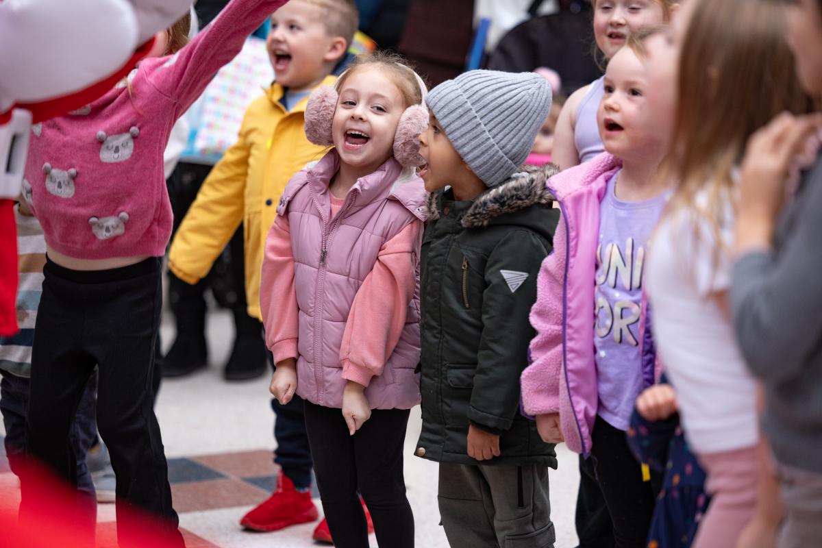 Crowd of kids laughing and dancing at live childrens show at The Marlands