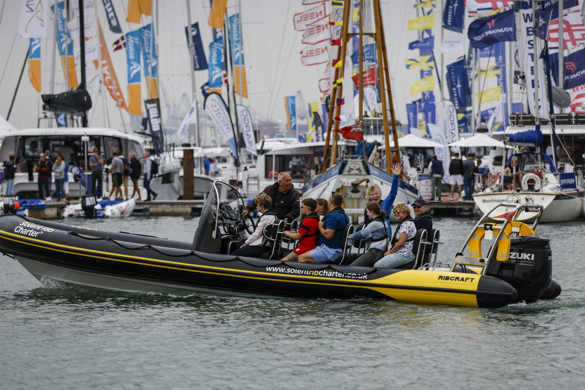 Family in speedboat driving on water at Southampton International Boat Show