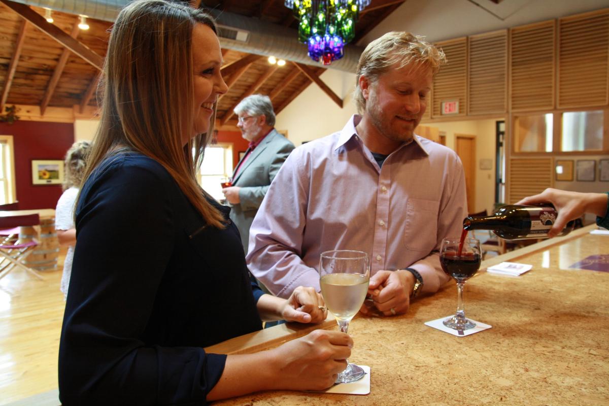 Two people at Sunset Point Winery Bar