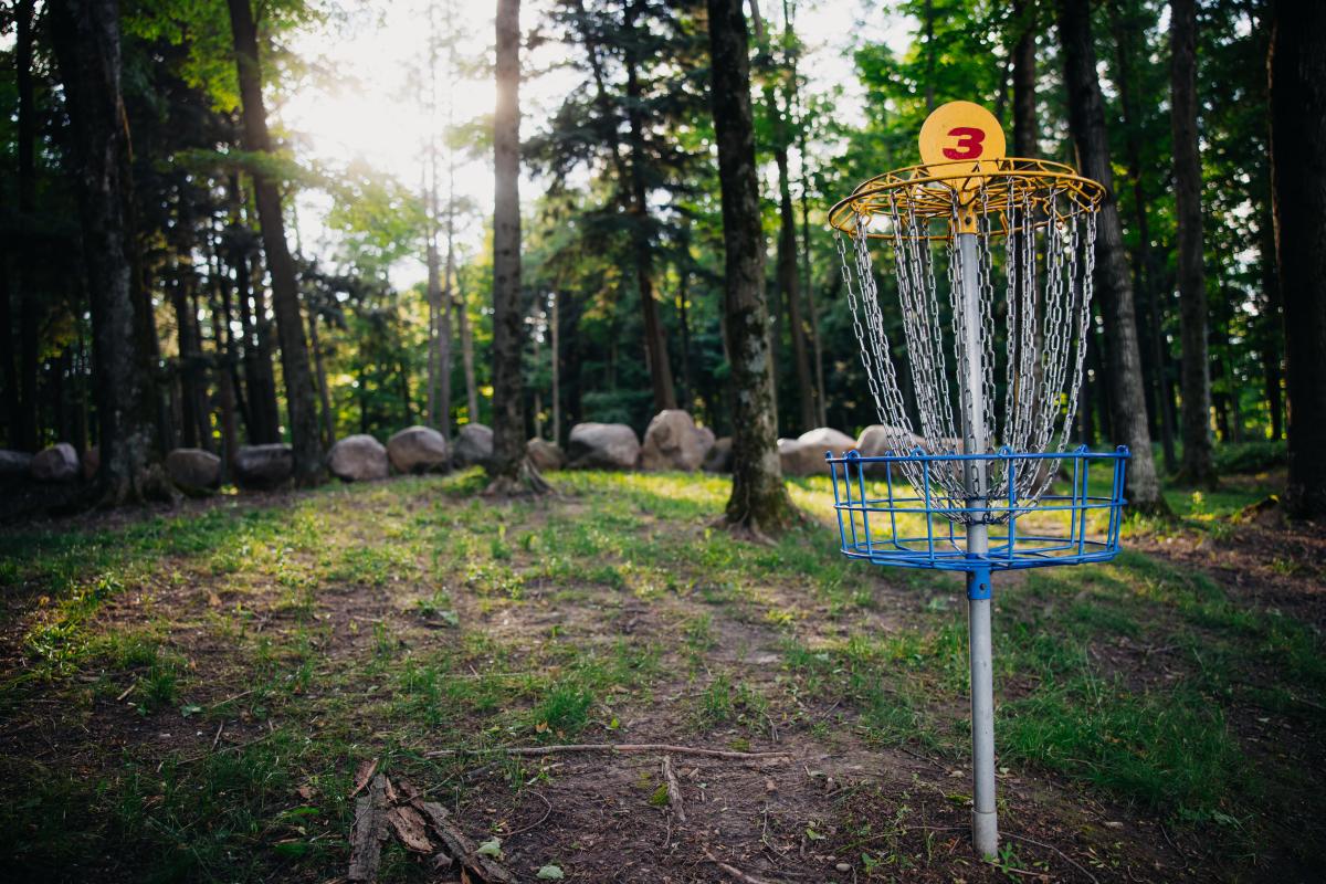 A summer disc golf spot in Wisconsin Lions Camp inclusive for blind and visually impaired people.