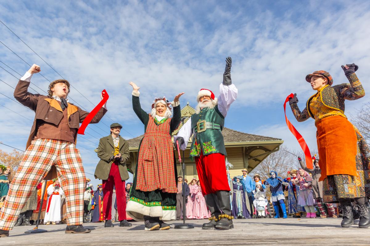 Santa and other Christmas Traditions characters cut the ribbon signifying the start of the season in St. Charles, Missouri.