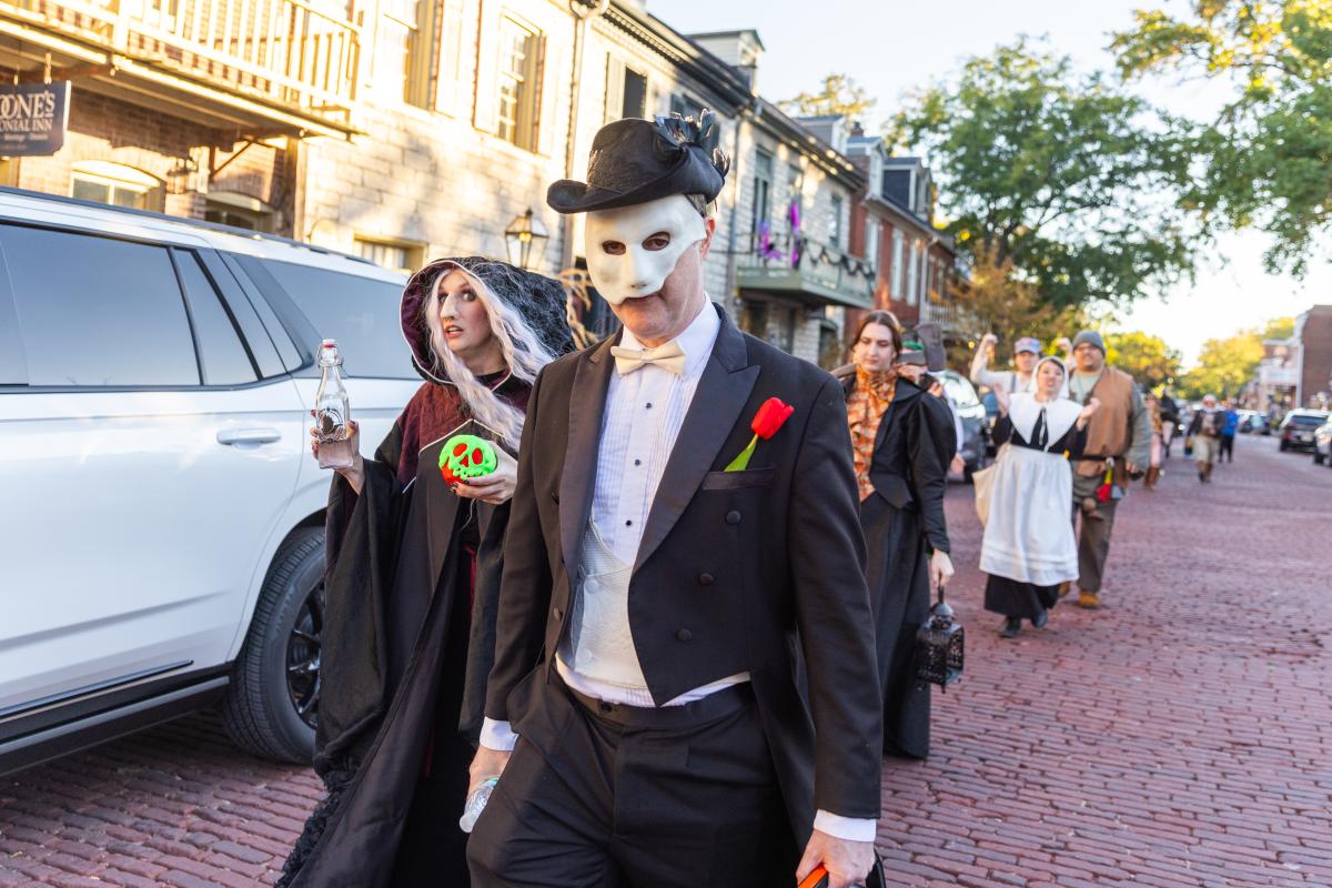 Characters from Legends & Lanterns walk down historic Main Street on a fall afternoon in St. Charles, Missouri.