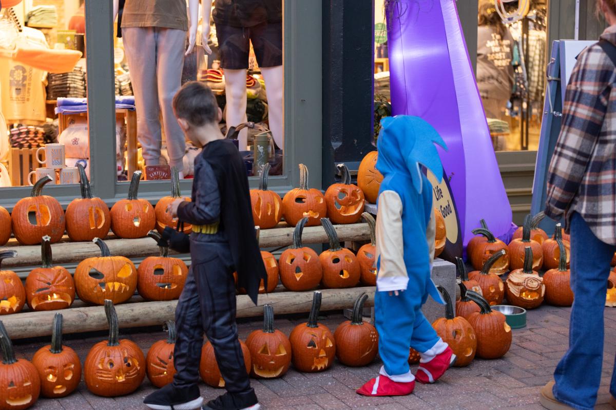 Children look at dozens of jack-o-lanterns on Main Street during Pumpkin Glow in St. Charles, Missouri.
