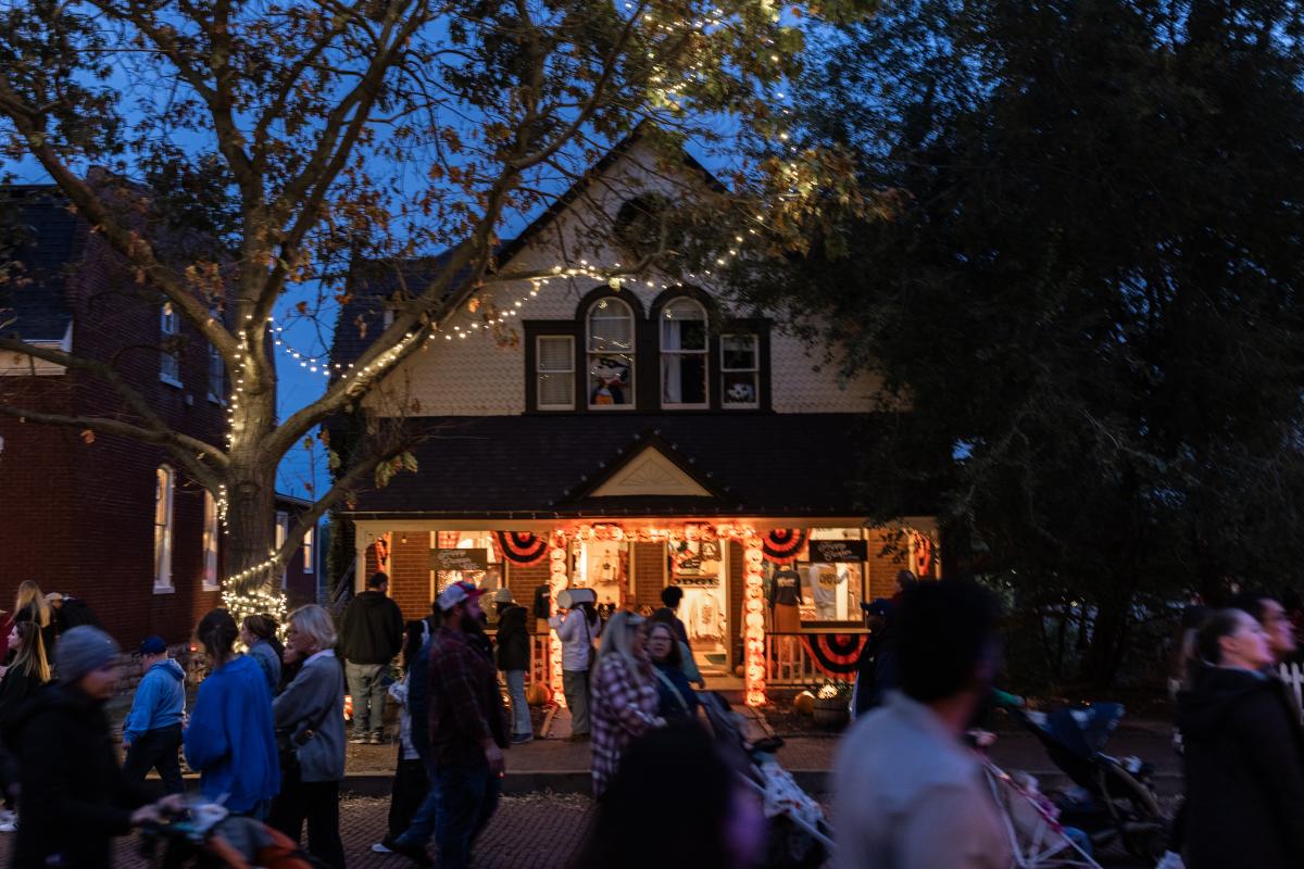 A storefront on Main Street in St. Charles with Halloween decorations at night during Legends & Lanterns.