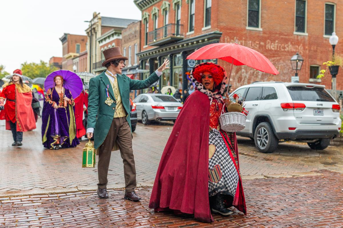 Legends & Lanterns walk down Historic Main Street while carrying umbrellas on a rainy day in St. Charles, Missouri.