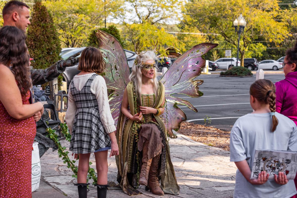 A character from Legends & Lanterns interacts with visitors on Historic Main Street in St. Charles, MO.