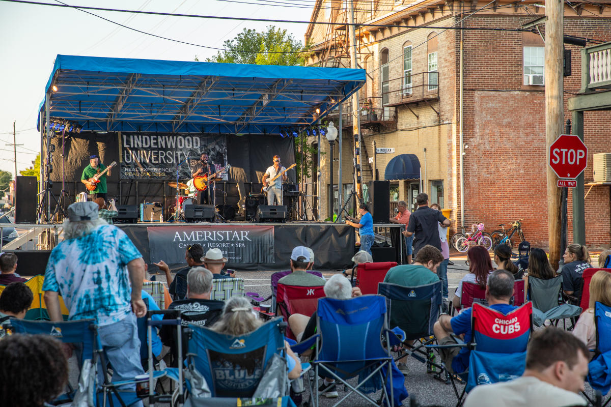 A stage with a band playing music in front of an audience.