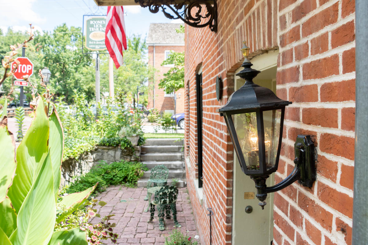 A close up of an antique outdoor light by the door of Boone's Lick Trail Inn in St. Charles, Missouri.
