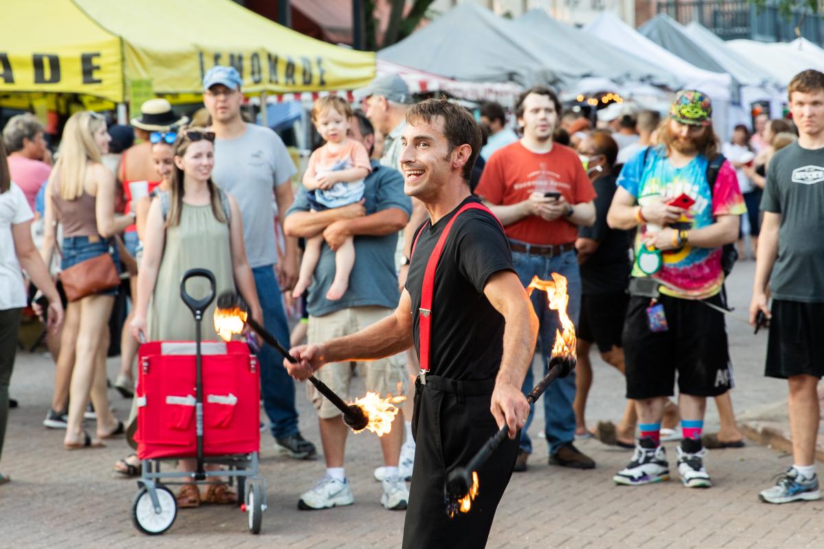 A performer twirling sticks on fire at a show at the Festival of the Little Hills in St. Charles, Missouri.