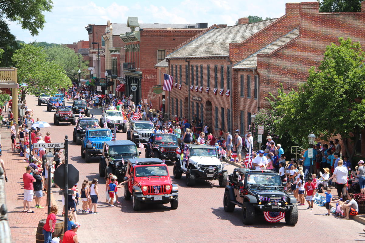 People and Cars in the street during Riverfest Parade 2018