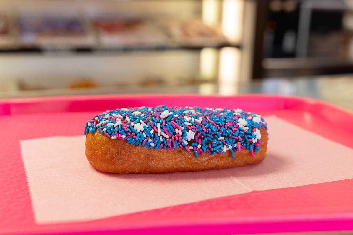 Donut King Long John, vanilla with pink and purple sprinkles