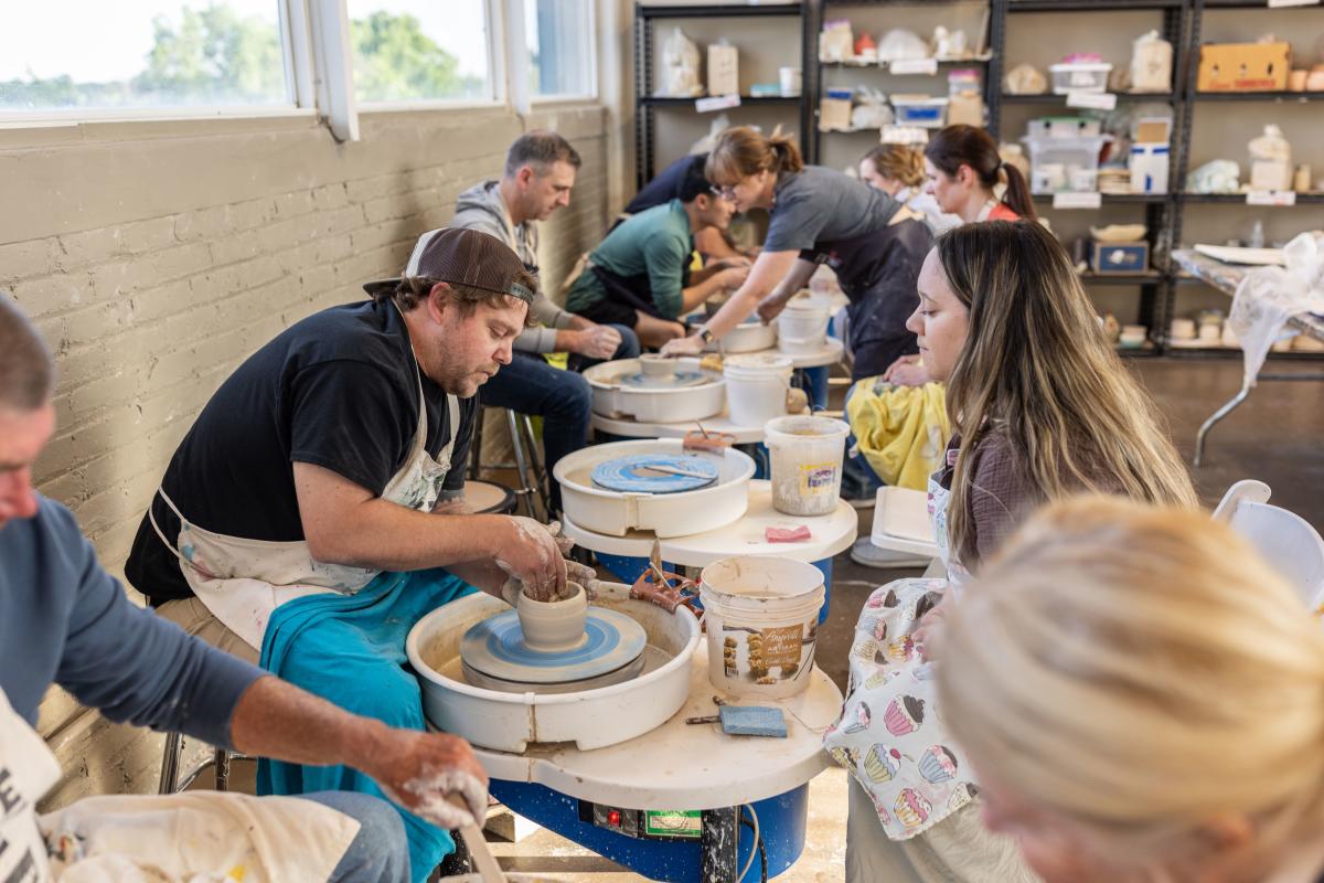 People taking a clay wheel throwing art class at the Foundry Art Centre in St. Charles, Missouri.