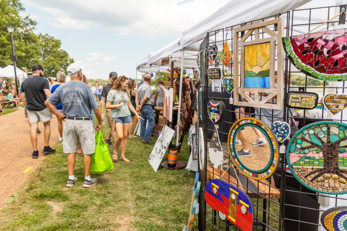 People browsing craft and artisan booths at the Festival of the Little Hills in Frontier Park St. Charles, Missouri.