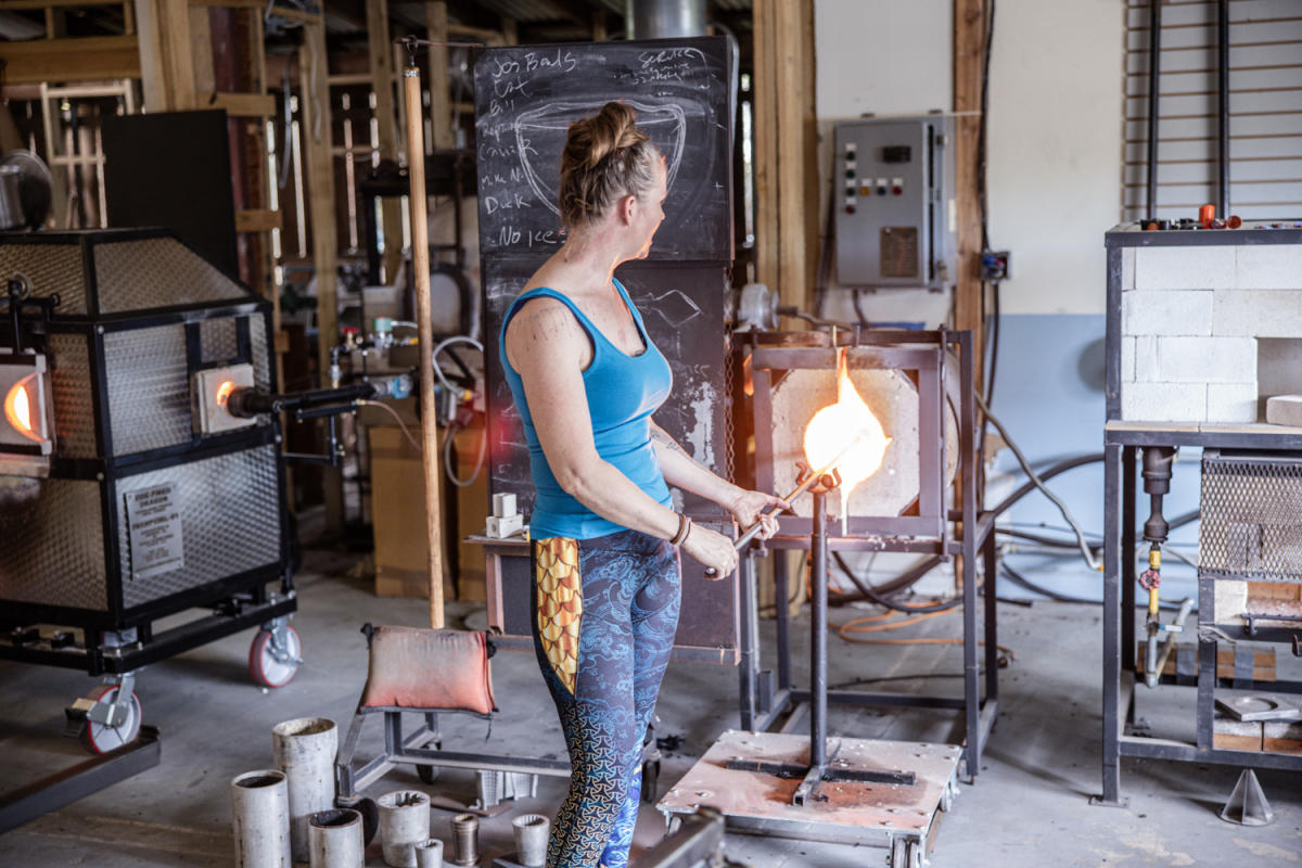 Solange Ledwith, owner of Swamp Girl Glass Blowing, creates a hand-blown glass vase.