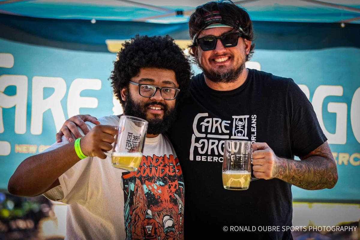 Brewers from Care Forgot Beercraft raise glasses of beer at Northshore Beer Fest in Mandeville.