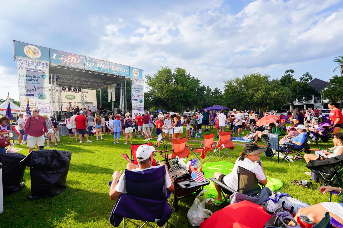 Guests spread out across the lawn in front of the music stage at the annual "Light Up the Lake" celebration of Independence Day in Mandeville.