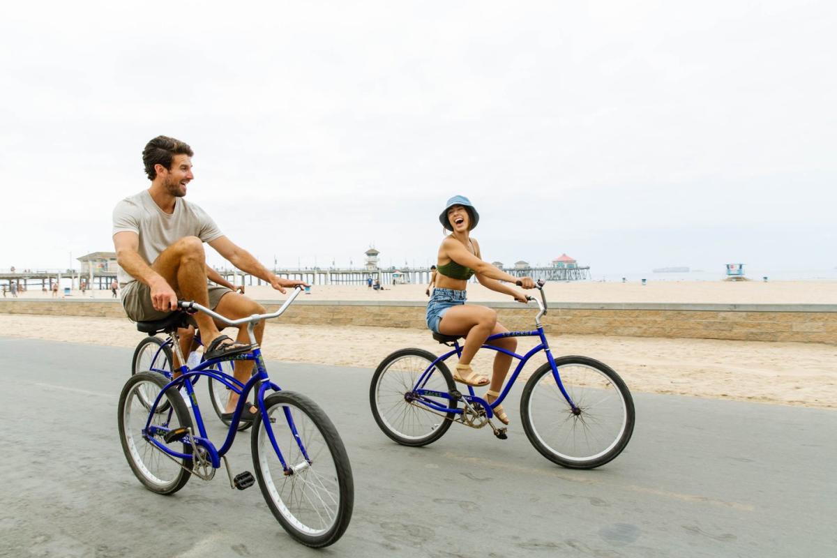 Bike Riding at Huntington Beach | Couple enjoying bike riding on the Huntington Beach Strand