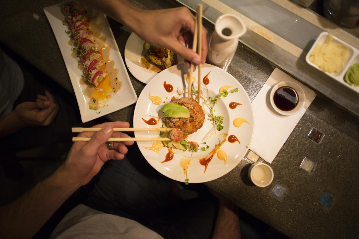 Patrons enjoying entrées at Sushi on Fire in Huntington Beach