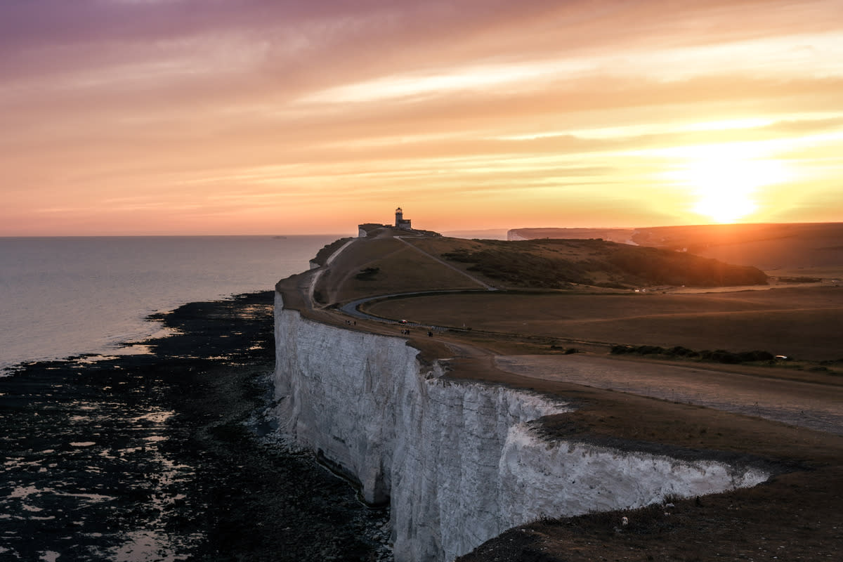 Cliffs and lighthouse at sunset