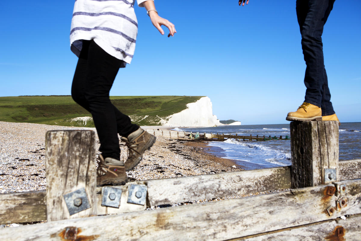 A couple of walkers on the beach at Birling Gap near Seven sisters in the South Downs National Park