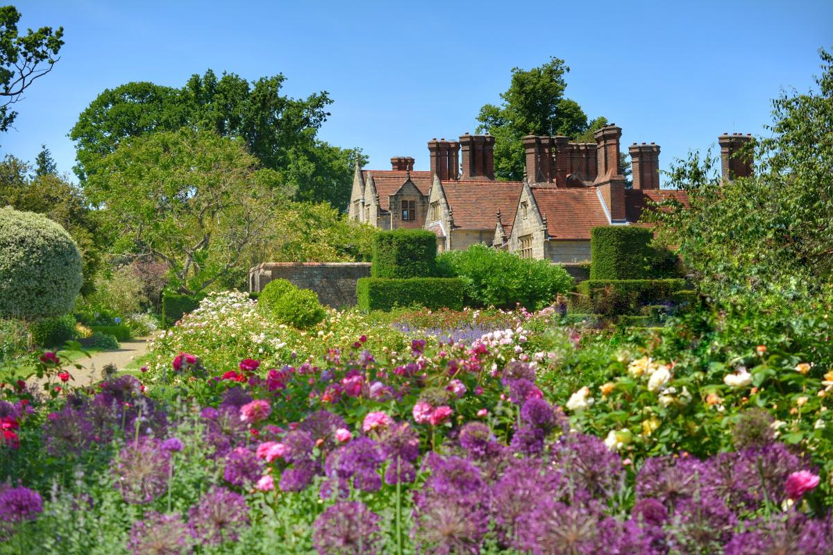 Pretty flower beds and manor house at Borde Hill Garden, Sussex