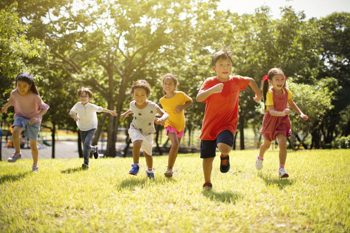 Six children running in the sun.