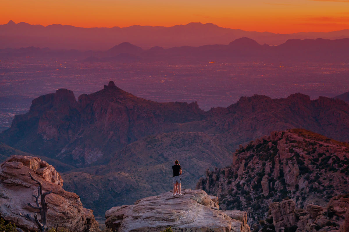 Man and woman embracing on an overlook at Sunset on Mt Lemmon in Tucson
