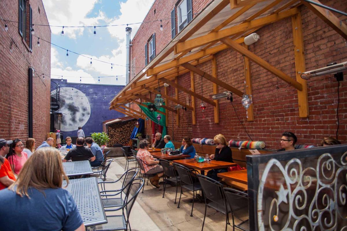 People Enjoying The Patio At East Village Bohemian Pizzeria In Tulsa, OK