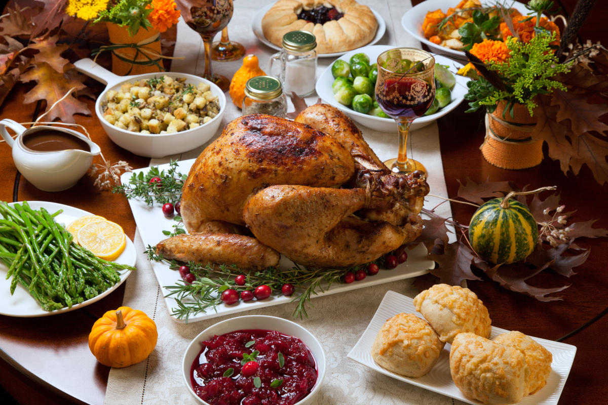 Roast Turkey on a table of Thanksgiving food