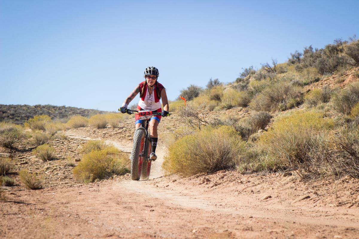 Woman riding a fat bike mountain bike in the Utah desert