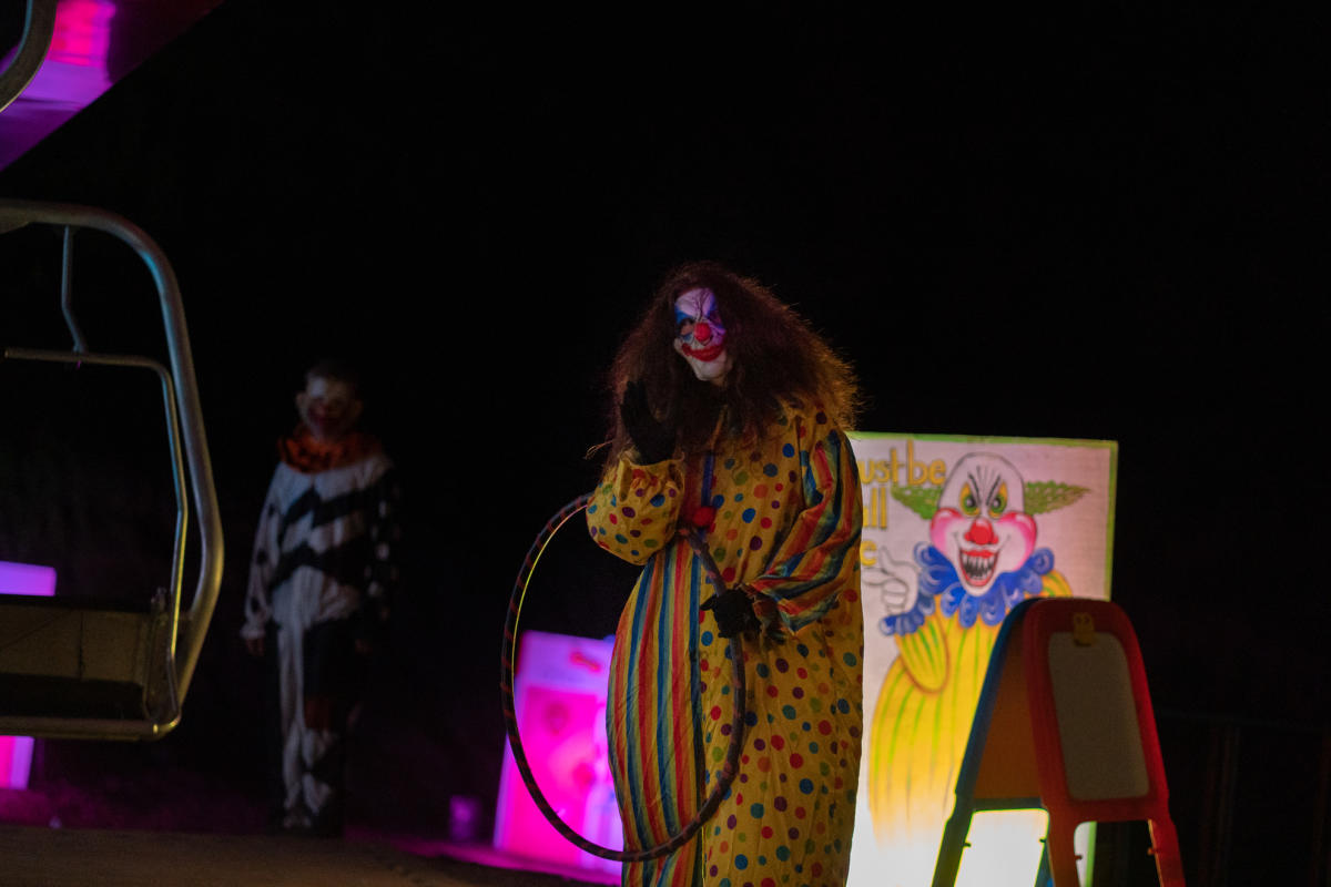 A creepy clown waves hello